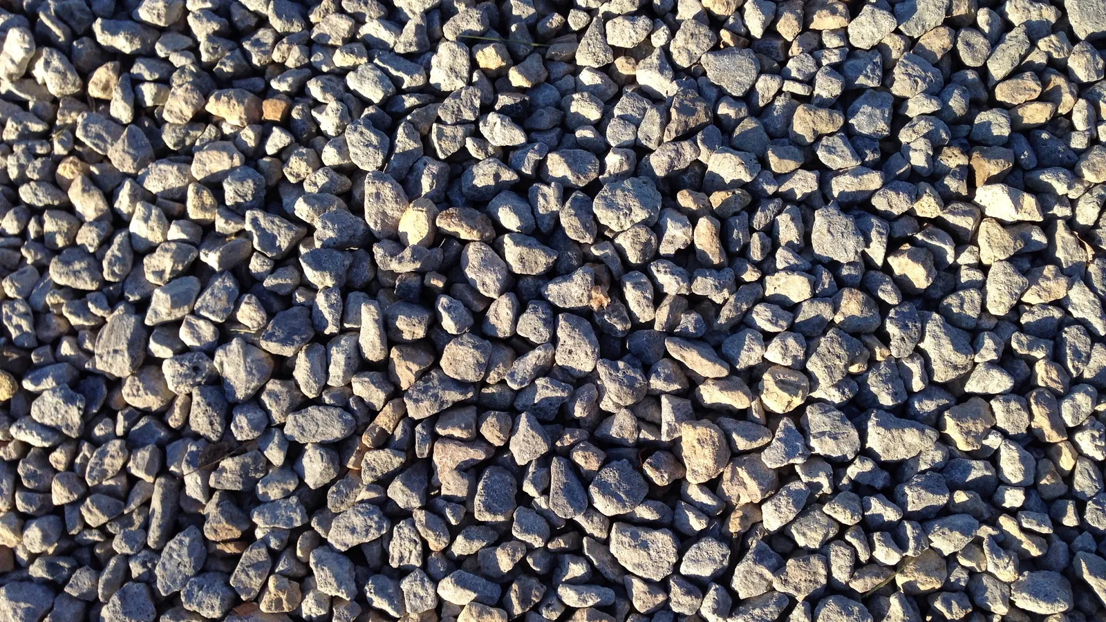 Close-up of angular crushed stone on a gravel driveway